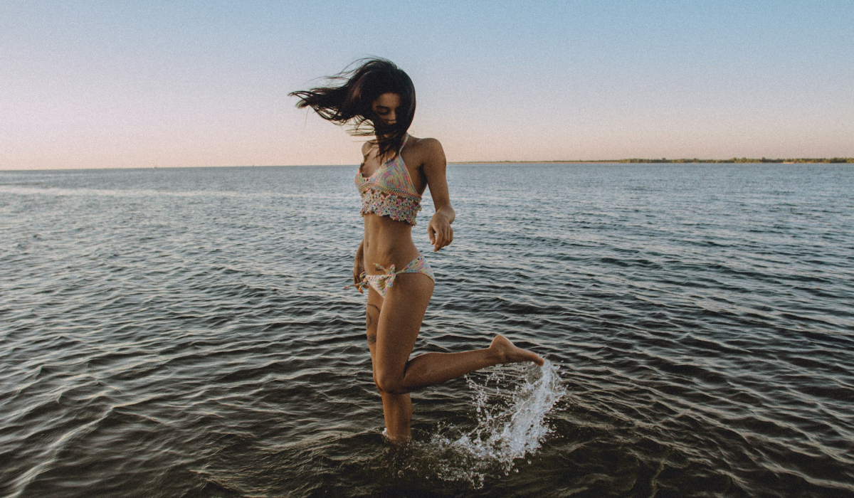 Captivating Moments: Woman Splashing Water at Beach