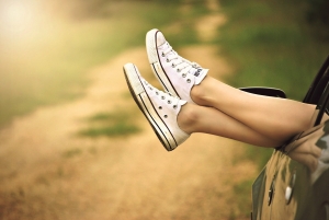 Embracing Nature: A Woman's Relaxing Car Journey on a Dirt Road