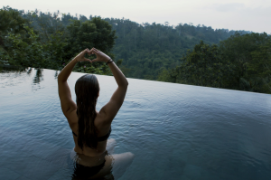 Embracing Nature's Serenity: Woman in Infinity Pool in Ubud, Indonesia