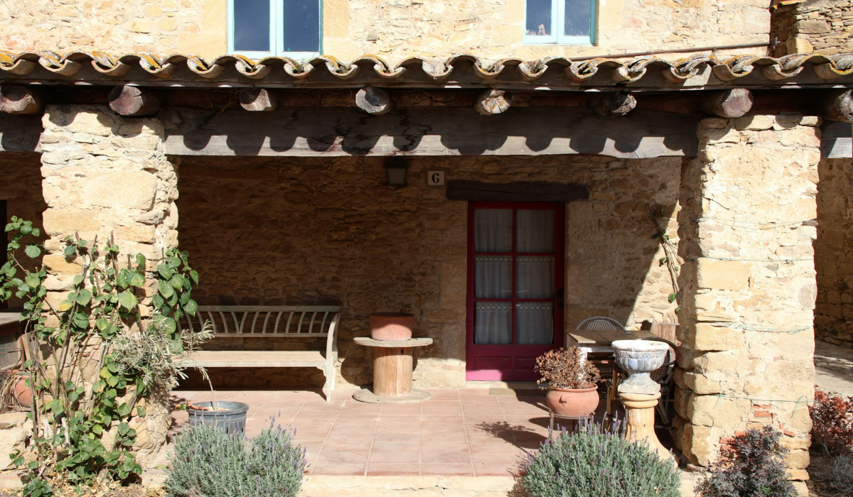 Experience Rustic Charm at a Traditional Catalan Masia: A Scenic Patio in Peratallada, Spain