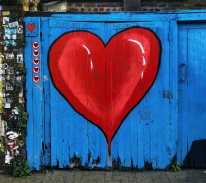 Expressive Love Art on a Blue Wall: The Captivating Red Heart Series
