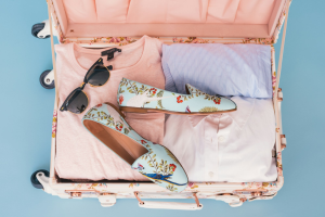 Packing Essentials: Stylish Clothing and Accessories in a Floral Suitcase