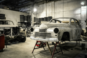 Restoration Journey: White Vintage Car in a Busy Garage Workshop