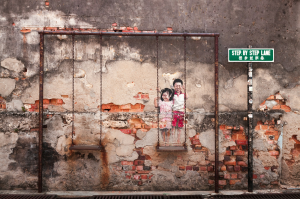 Rustic Charm of Penang, Malaysia: Children at Play Amidst Aged Walls