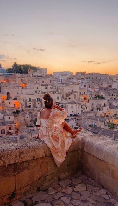 Serene Cityscape: Overlooking the Sunset from a Skyscraper Ledge