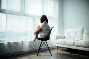 Sunlit Serenity: A Girl's Contemplative Moment in Modern Interior