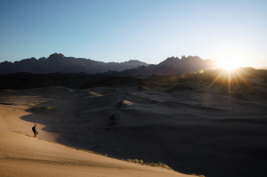 Sunset Glow Over NEOM's Iconic Red Sand Dunes and Mountain Valleys