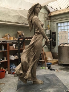The Dance of Clay: A Sculpted Woman in Motion