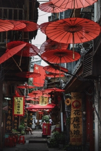 Urban Inspirations: A Journey Through a Vibrant Alleyway Adorned with Red Umbrellas